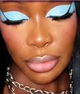 Bold cut-crease eye makeup in striking sky blue with long lashes
